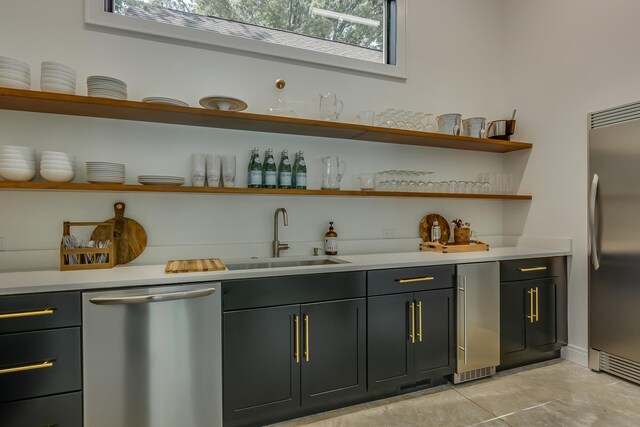 15963 Lakeshore Rd, Union Pier, MI 49129 - bar with wet bar, plenty of natural light, light tile patterned flooring, stainless steel appliances, and a sink