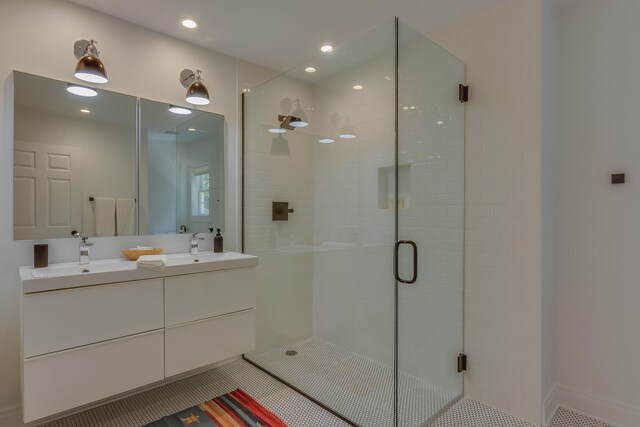 15963 Lakeshore Rd, Union Pier, MI 49129 - bathroom featuring recessed lighting, double vanity, a sink, and a stall shower