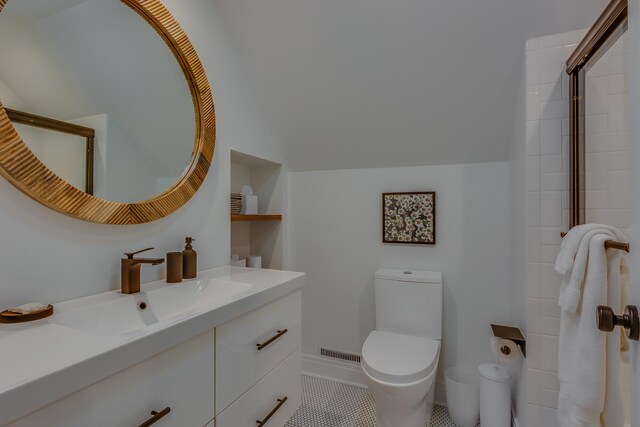15963 Lakeshore Rd, Union Pier, MI 49129 - full bathroom with vanity, visible vents, vaulted ceiling, and toilet