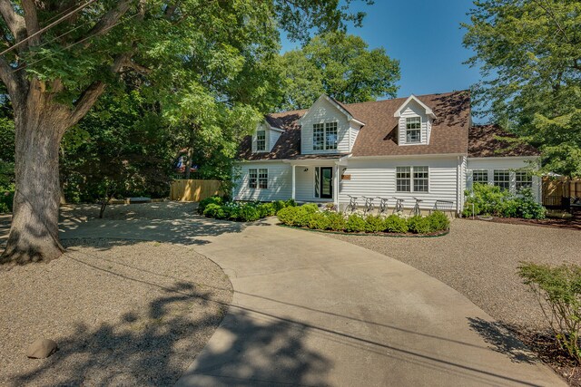 15963 Lakeshore Rd, Union Pier, MI 49129 - new england style home featuring roof with shingles and fence