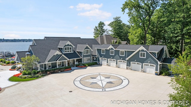 view of front of property with a water view and a garage