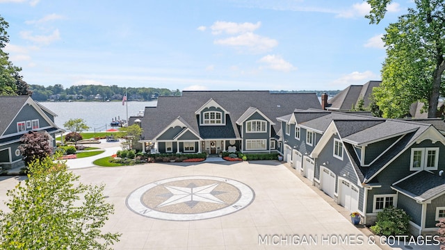 exterior space featuring a garage and a water view