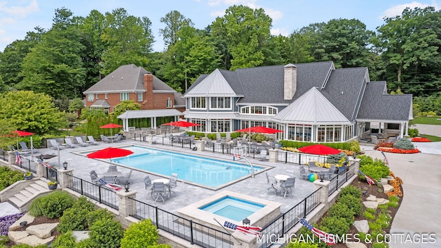 view of swimming pool with an in ground hot tub and a patio