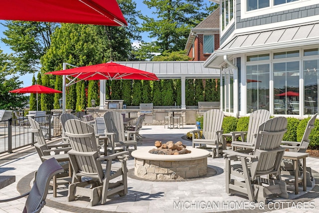 view of patio / terrace with a grill and a fire pit