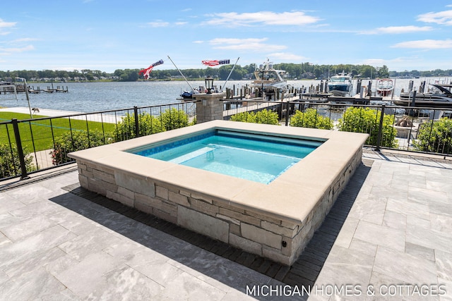 view of pool featuring an in ground hot tub and a water view