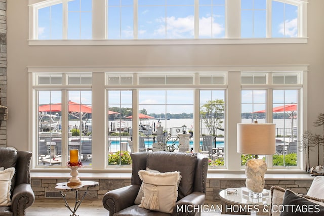 living room featuring a healthy amount of sunlight and a water view