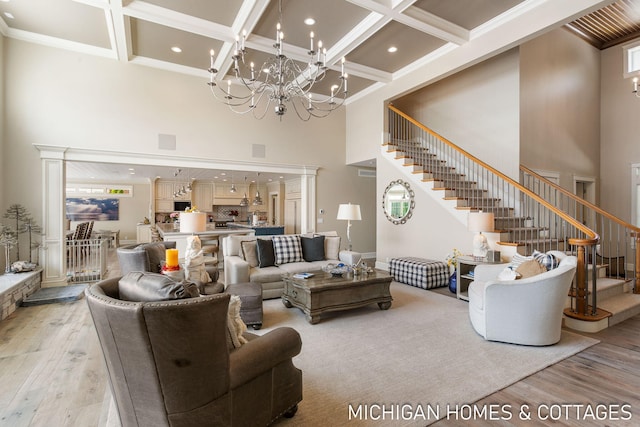 living room featuring coffered ceiling, beam ceiling, and light wood-type flooring