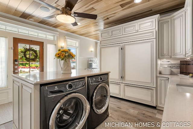 laundry area with crown molding, light hardwood / wood-style flooring, ceiling fan, washing machine and clothes dryer, and wooden ceiling