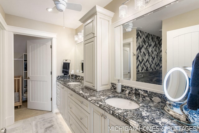 bathroom featuring vanity, ceiling fan, and walk in shower