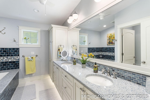 bathroom with vanity, a healthy amount of sunlight, and ceiling fan