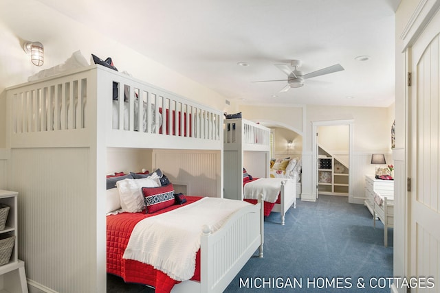 bedroom featuring dark carpet and ceiling fan