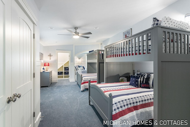 bedroom with ceiling fan and dark colored carpet