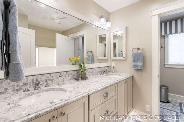 bathroom featuring tasteful backsplash, vanity, and ceiling fan