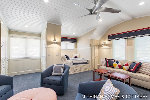 living room with dark colored carpet, plenty of natural light, and vaulted ceiling with beams