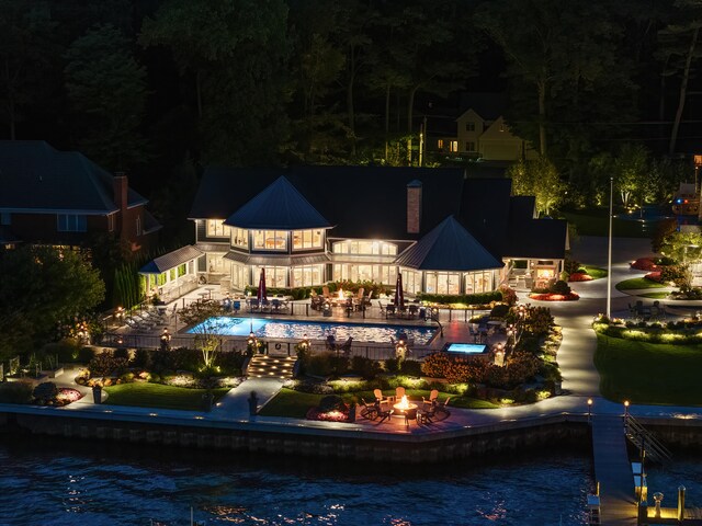 view of pool featuring a patio and a water view