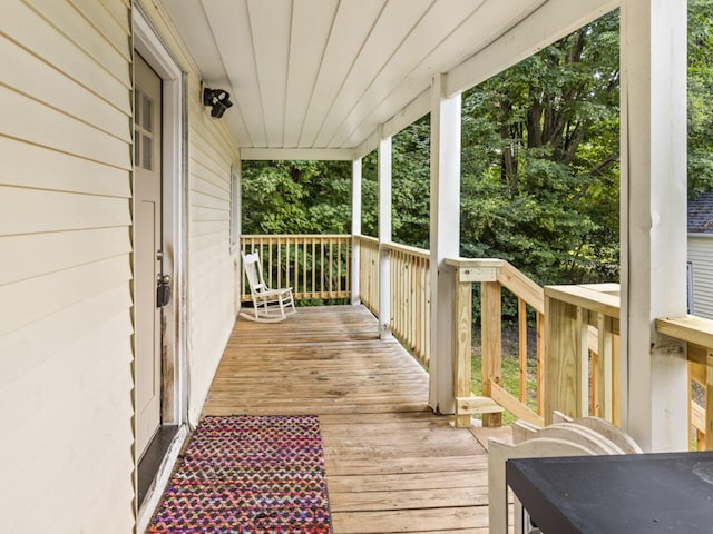 wooden terrace featuring covered porch