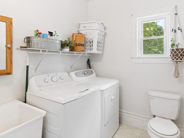 washroom featuring washing machine and clothes dryer and sink