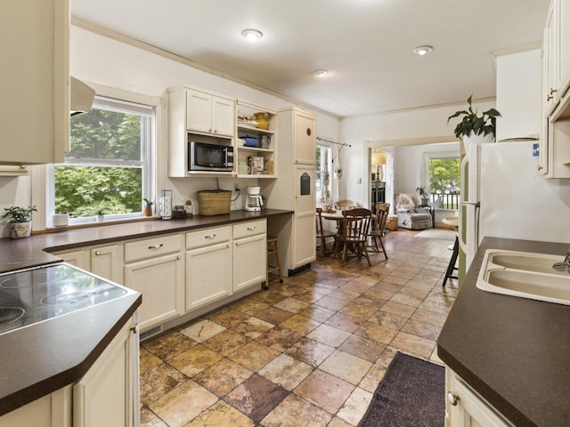 kitchen featuring crown molding, white cabinetry, and sink