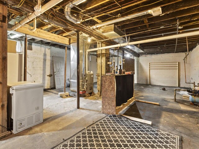 basement with heating unit and refrigerator