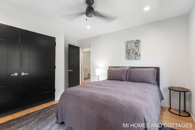 bedroom with a closet, light wood-type flooring, and ceiling fan