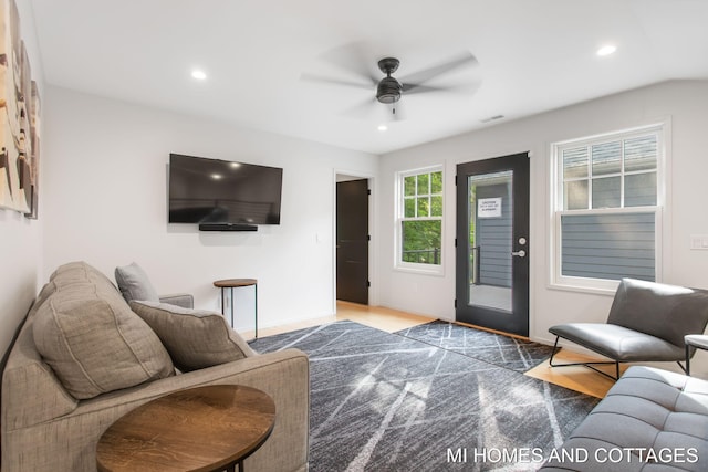 living room with hardwood / wood-style floors and ceiling fan