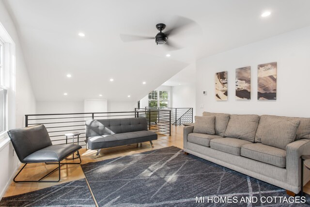 living room with ceiling fan and light wood-type flooring