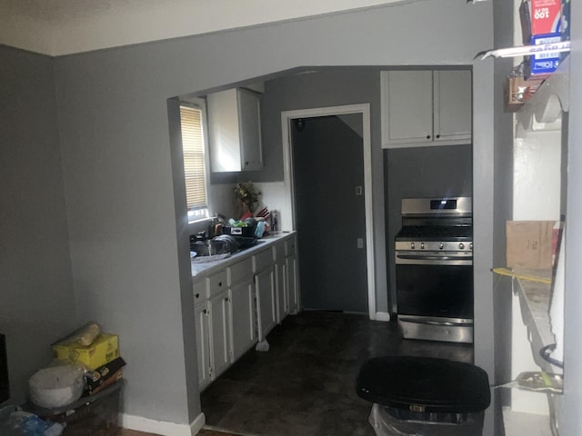 kitchen with white cabinetry, sink, and gas stove