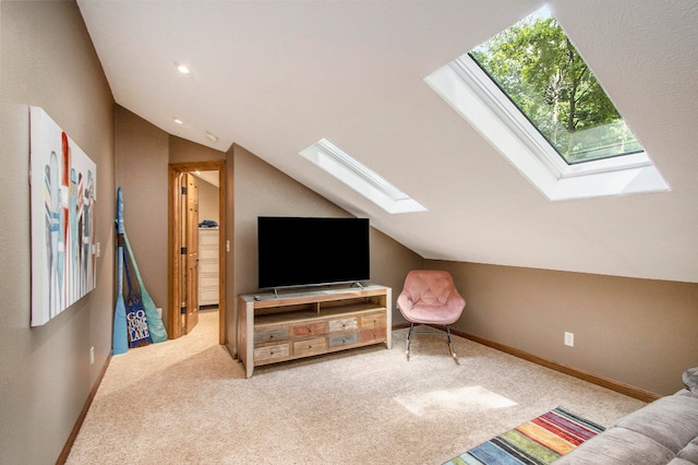 carpeted living room featuring vaulted ceiling with skylight