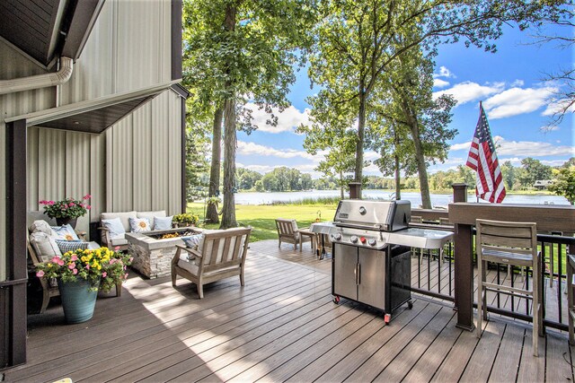 wooden terrace featuring a water view, a grill, and an outdoor living space with a fire pit