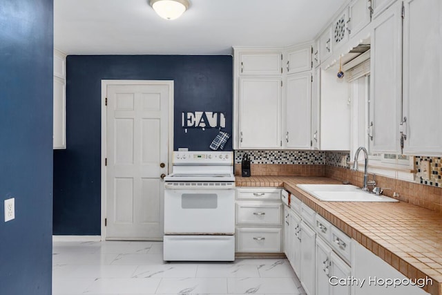 kitchen with sink, white electric range oven, tile counters, white cabinets, and decorative backsplash