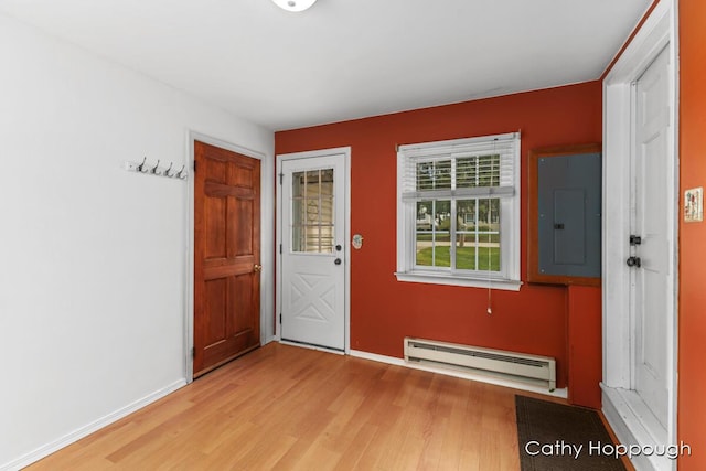 entryway featuring electric panel, baseboard heating, and light hardwood / wood-style flooring