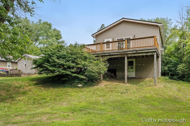 back of house featuring a wooden deck and a lawn