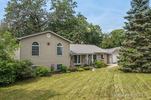 tri-level home with a garage and a front lawn