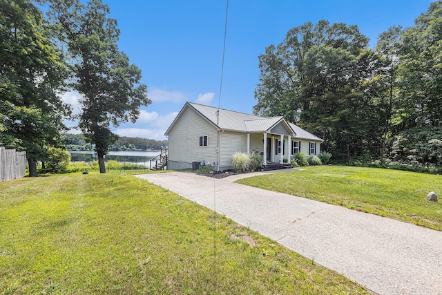 view of front facade featuring a front lawn and a water view