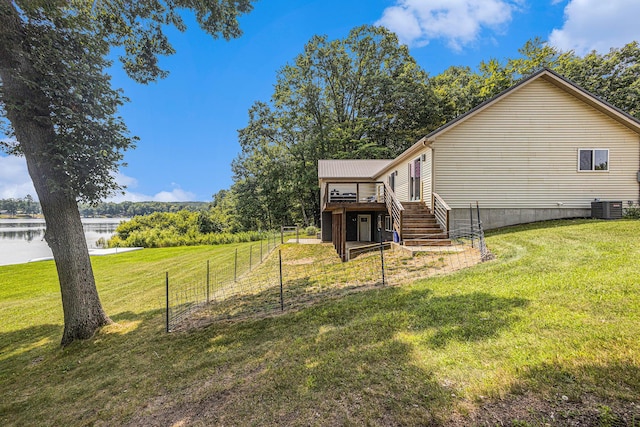 exterior space featuring cooling unit and a deck with water view