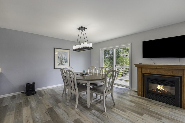 dining room featuring hardwood / wood-style flooring and a notable chandelier