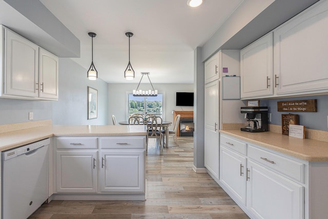 kitchen featuring white cabinetry, kitchen peninsula, and dishwasher