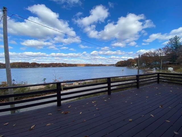 wooden terrace featuring a water view