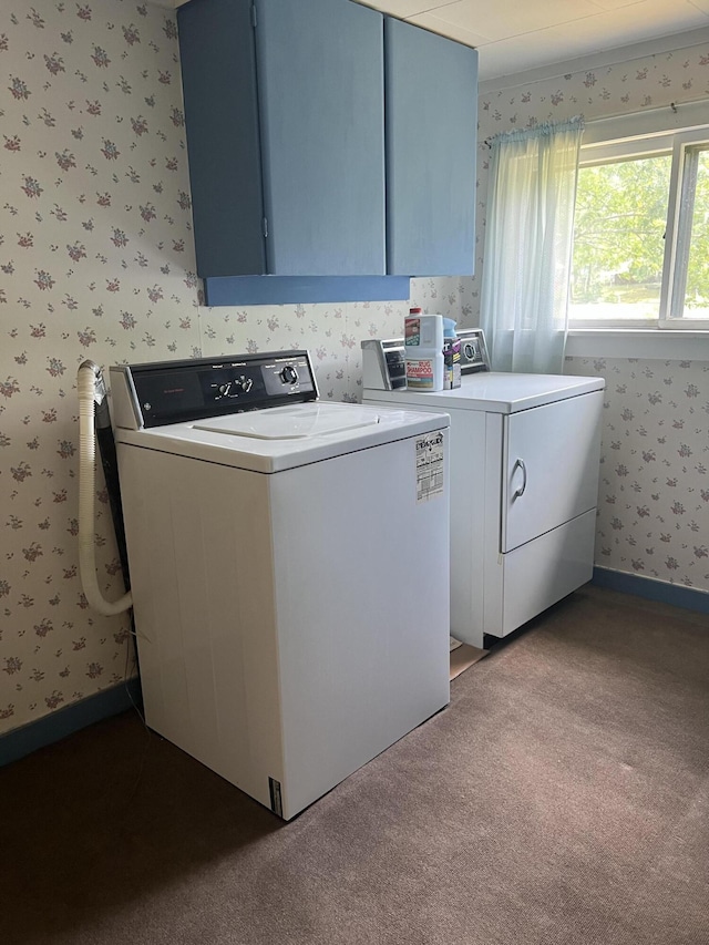 laundry area with cabinets, light colored carpet, and washer and clothes dryer