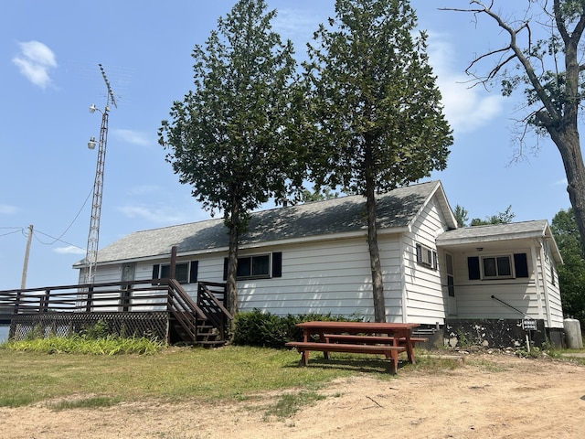 back of property featuring a yard and a deck