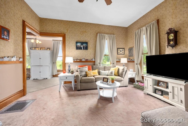 living room with ceiling fan, carpet flooring, and a wealth of natural light