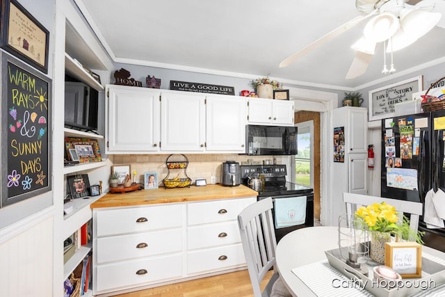 kitchen featuring white cabinets, decorative backsplash, black appliances, crown molding, and light wood-type flooring