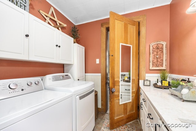 laundry room with cabinets, crown molding, and washer and clothes dryer