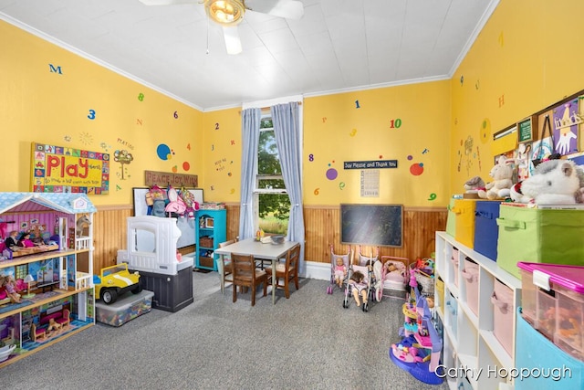 game room with ornamental molding, carpet, and ceiling fan