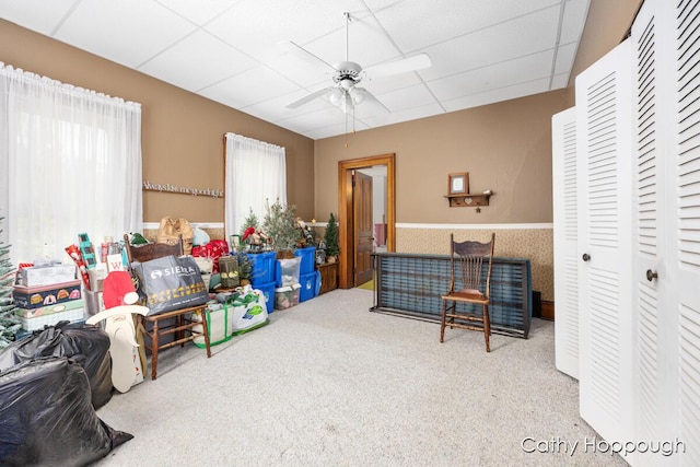 game room featuring a drop ceiling, carpet floors, and ceiling fan