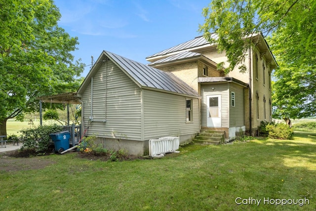 back of property with a pergola and a lawn