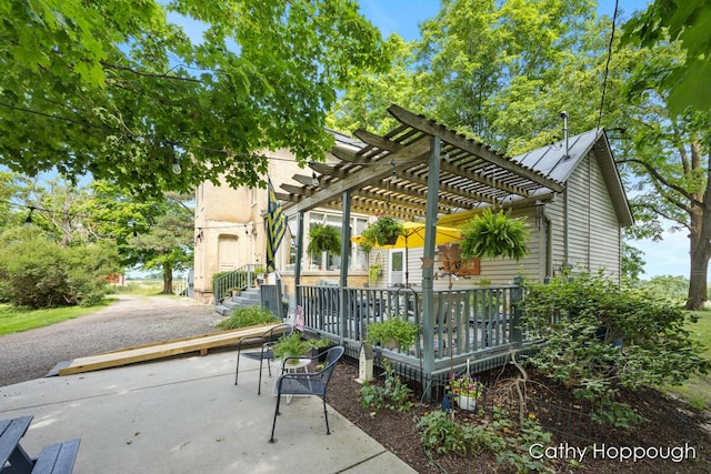 view of patio / terrace featuring a wooden deck and a pergola