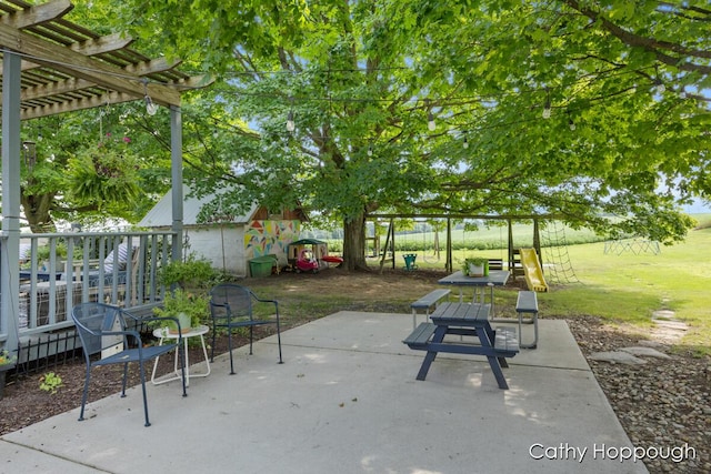 view of patio with a pergola and a playground