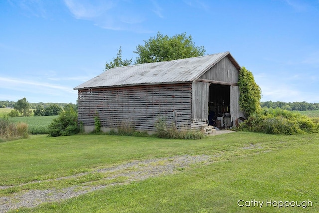 view of outbuilding with a yard