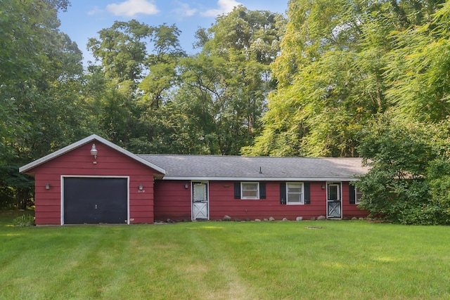 ranch-style home featuring a garage and a front lawn